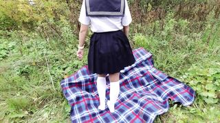 Schoolgirl in uniform shows legs feet foot in white knee socks and pantyhose under skirt