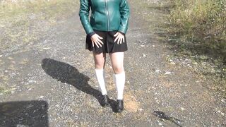 Schoolgirl in white knee socks and black shoes under the skirt